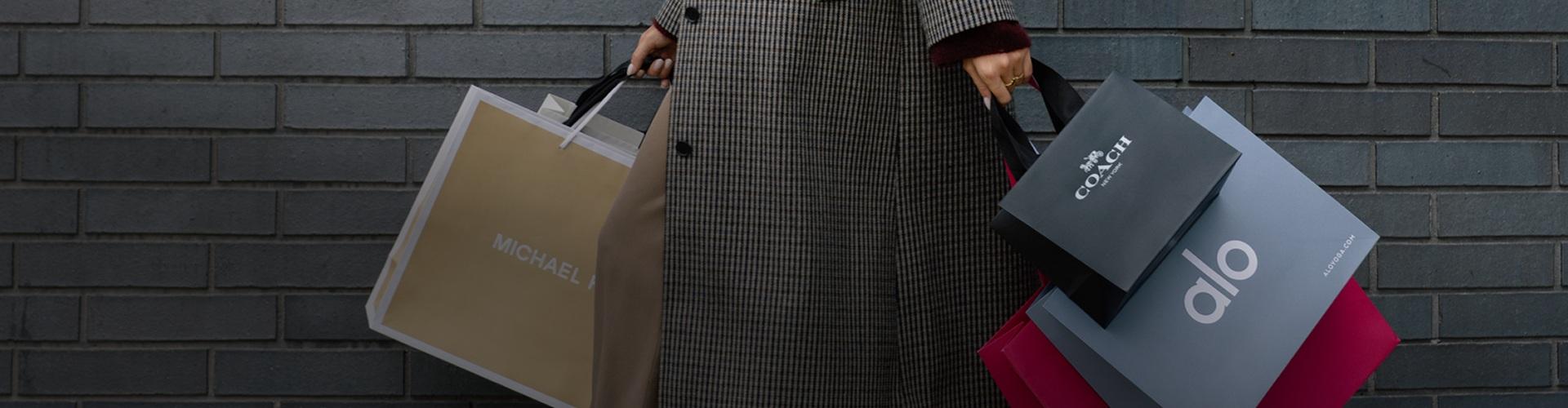 Shopper carrying multiple bags, showcasing exclusive deals and retail variety at the shopping centre