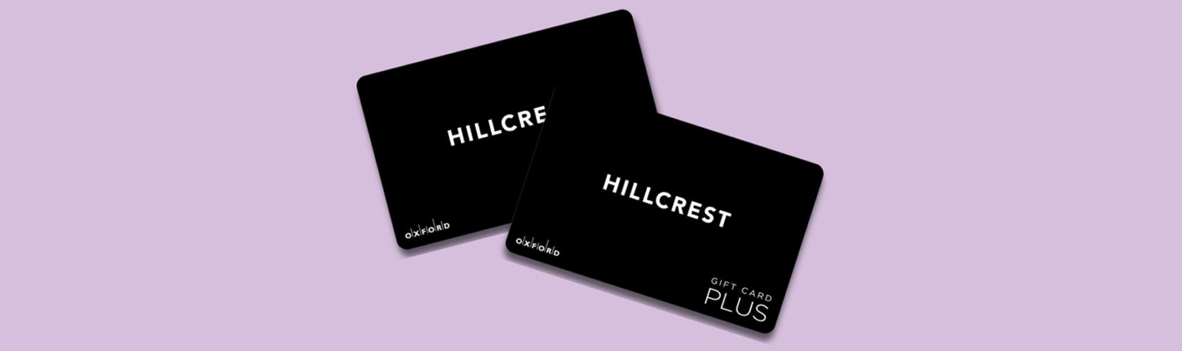 Two black Hillcrest Oxford gift cards on a lilac background