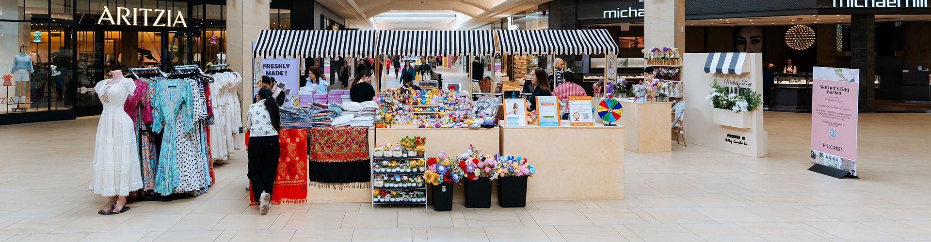 Mother's Day market stall with flowers and gifts outside Aritzia in a mall