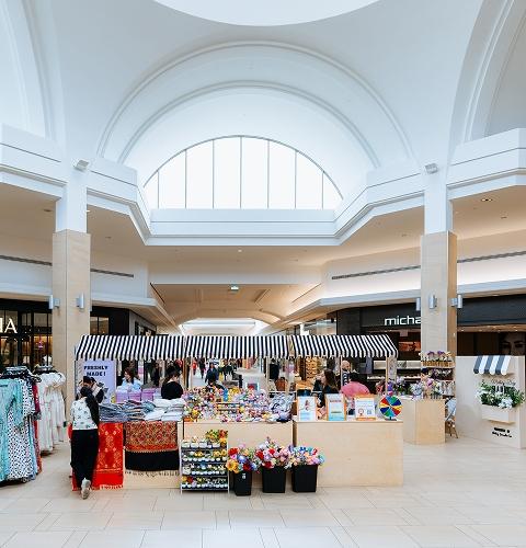 Mother's Day market stall with flowers and gifts outside Aritzia in a mall