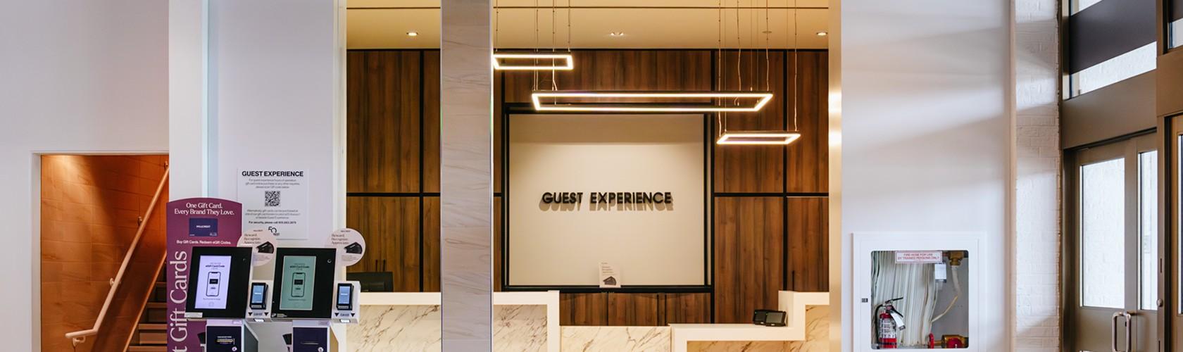 Hillcrest mall Guest Experience desk with gift card display and wood panelling