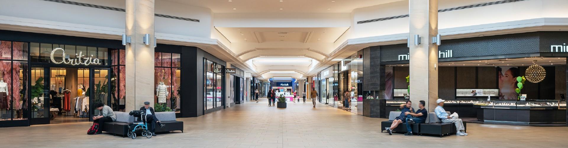 Mall concourse lined with Aritzia and Michael Hill and seating areas