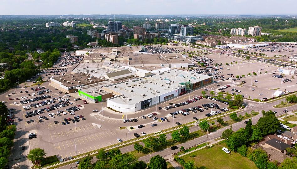 Aerial view of a suburban shopping mall surrounded by large parking lots