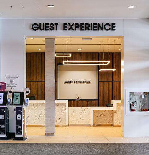 Guest Experience desk with gift card kiosks and warm wood panelling