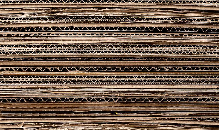 Close-up of a stack of flattened corrugated cardboard sheets