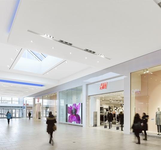 Sunlit mall interior with a skylight and H&M storefront