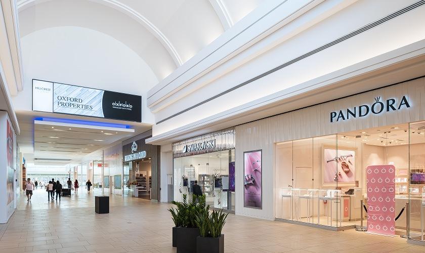 Mall walkway with Oxford Properties screen, Swarovski and Pandora stores