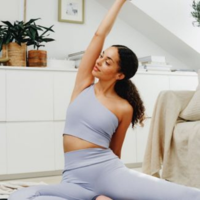 Woman in yoga pose in light blue athletic wear