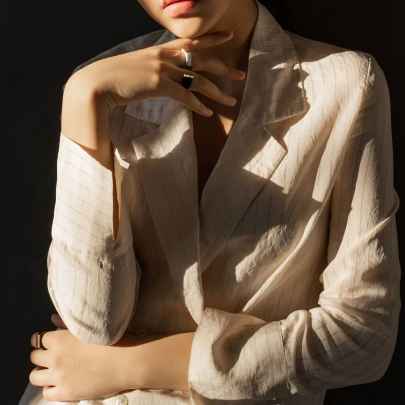 Woman posting in beige blazer top