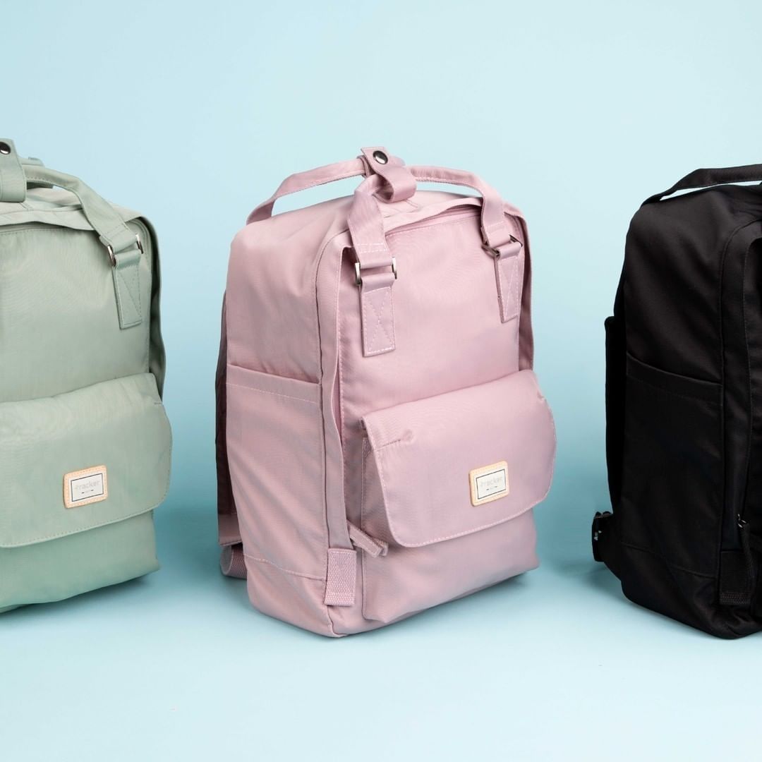 Three backpacks - green, pink, black