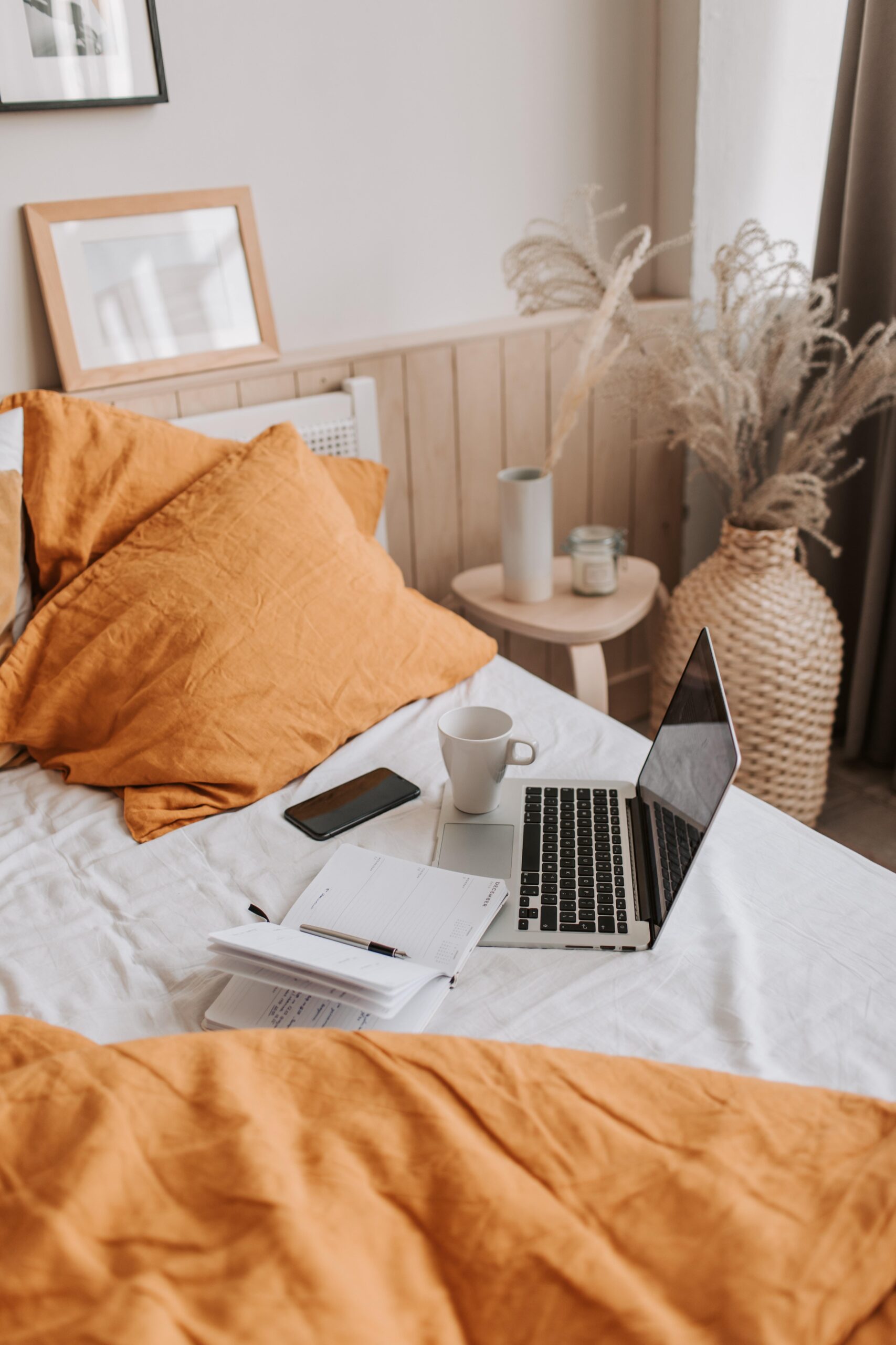 bed with laptop on top