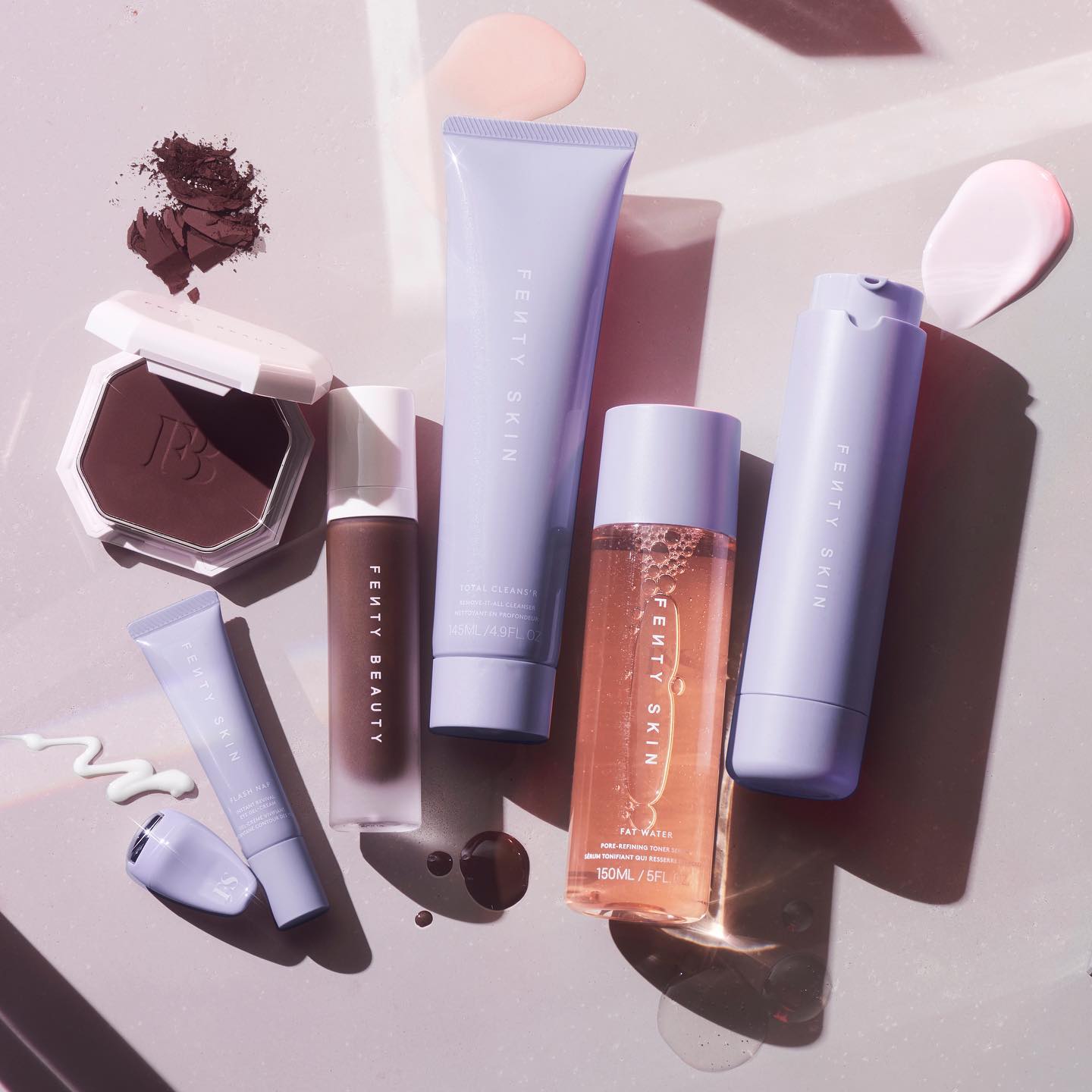 A flat lay image of beauty and skin products from Fenty Beauty and Fenty Skin by Rihanna.