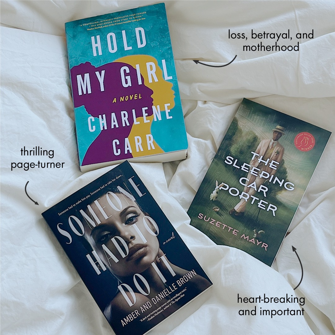 Three books from Indigo are laid out on a white duvet.