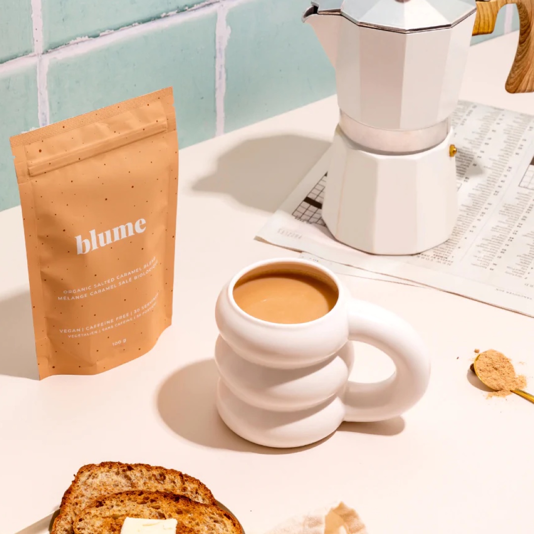 A cloud mug is featured on a counter top alongside Salted Caramel Blume mix from Indigo.
