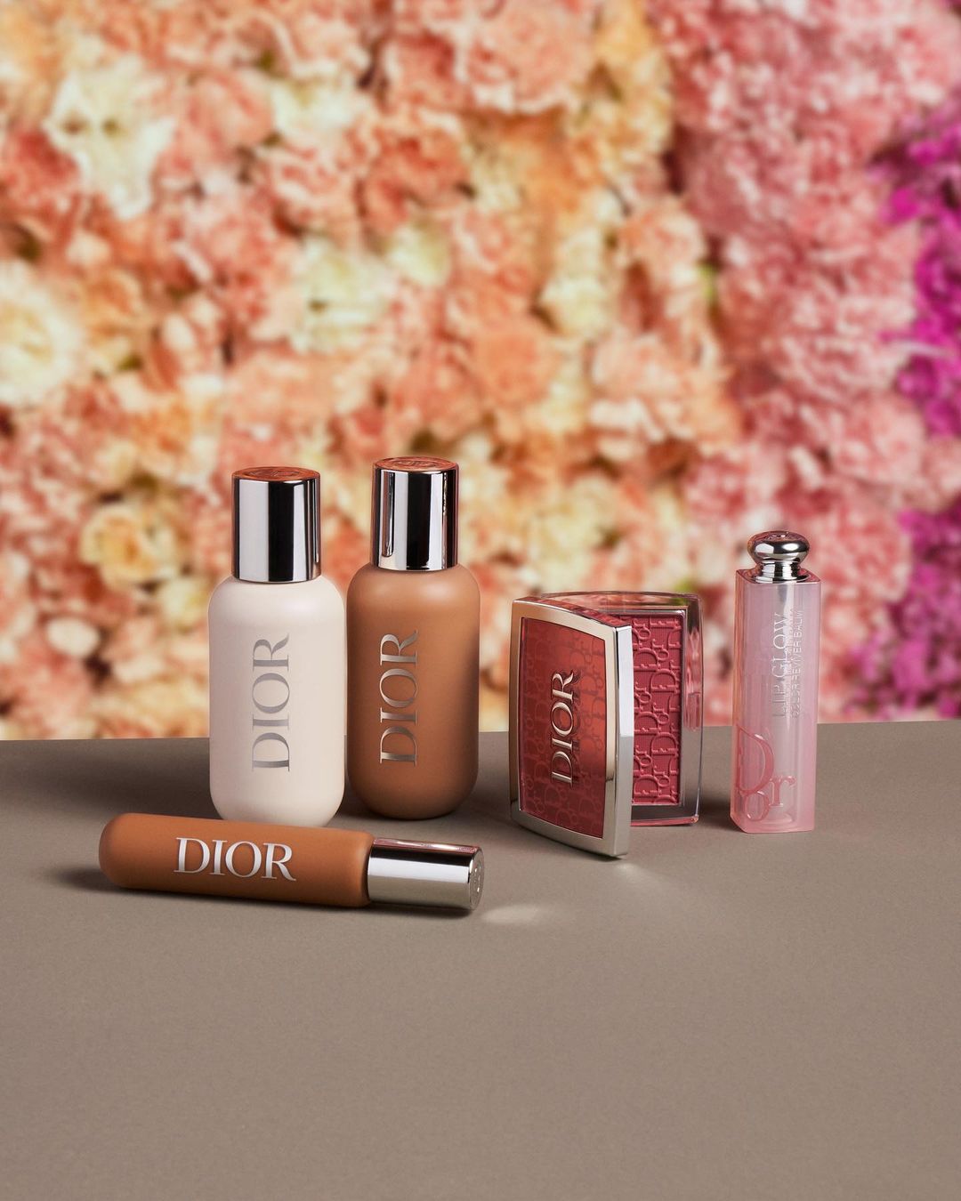 Image of an assortment of Dior beauty products with a floral backdrop