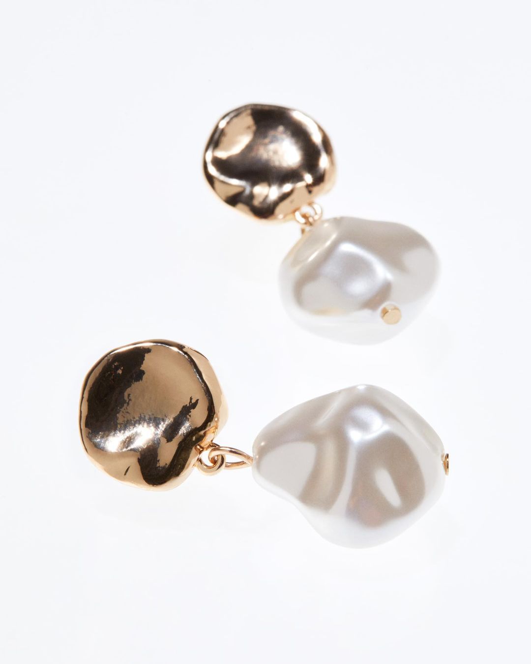a pair of gold and pearl earrings from H&M