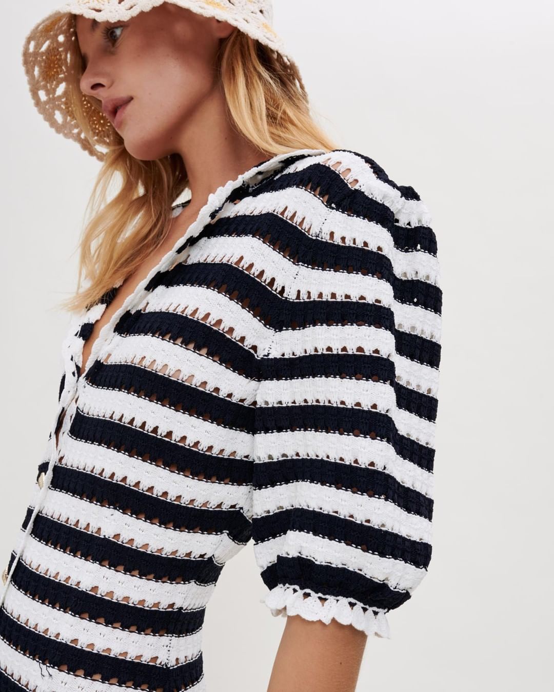 Black and white striped knit sweater with puffy sleeves.