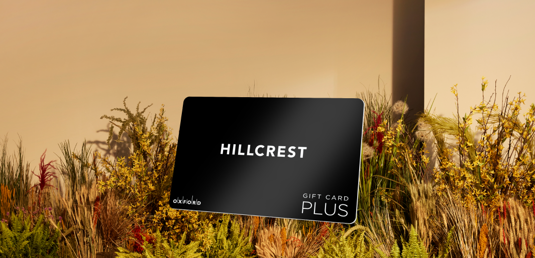 promotional image of a black Hillcrest gift card atop fall foliage