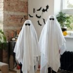 Two people with do-it-yourself ghost costumes.