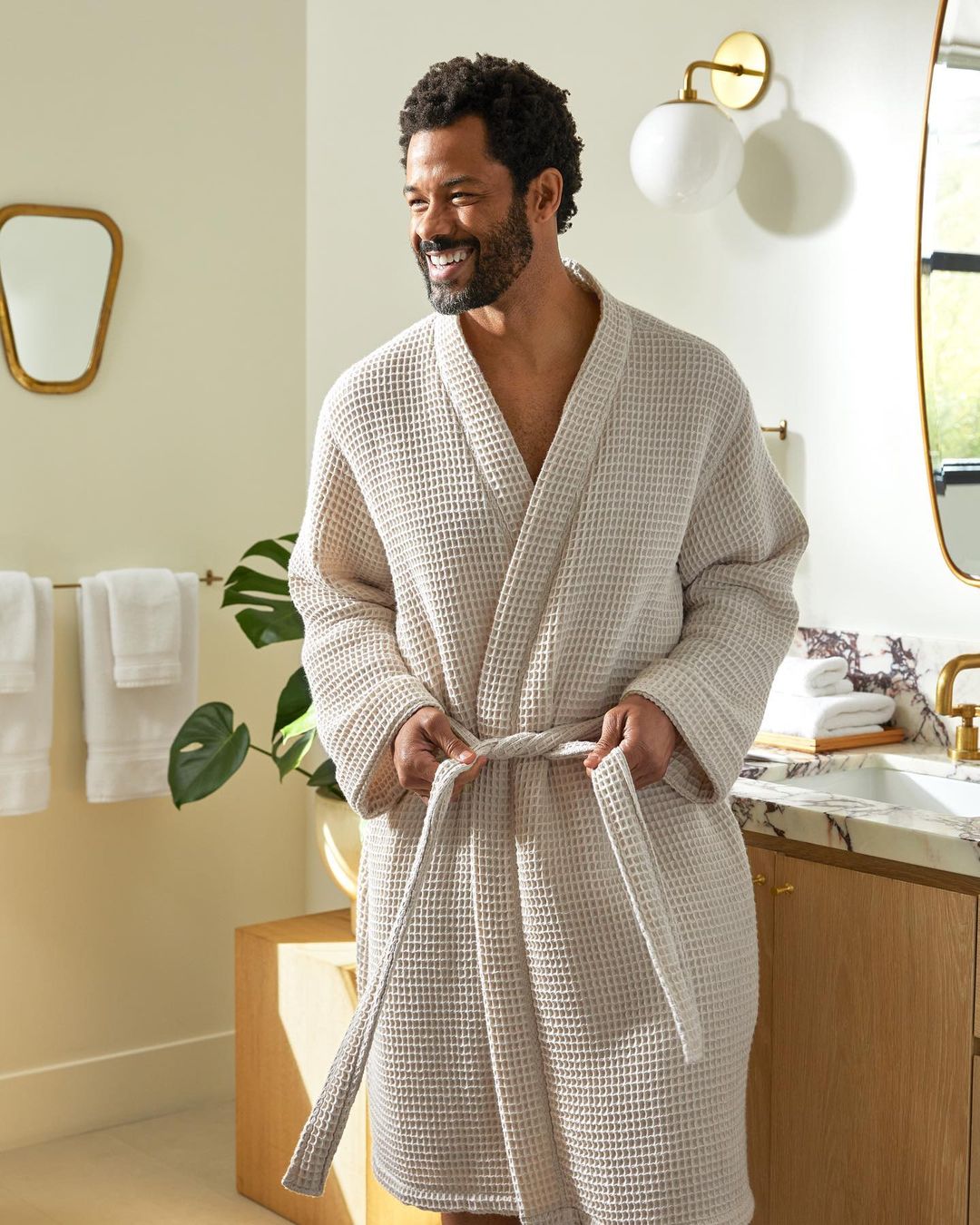 Man in bathroom wearing a robe
